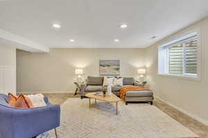 Carpeted living room featuring recessed lighting