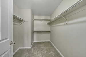 Walk in closet with light carpet