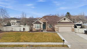 View of front of home with a gate, stucco siding, driveway, and an attached garage