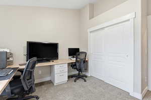 Office space featuring light carpet and baseboards