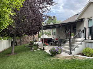 Fenced backyard with a patio area and an outdoor structure