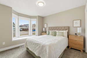 Bedroom featuring carpet flooring and baseboards