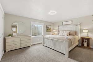 Carpeted bedroom featuring baseboards