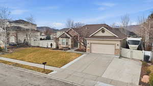Craftsman-style house with a gate, stucco siding, driveway, a mountain view, and stone siding