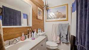 Bathroom with curtained shower and vanity