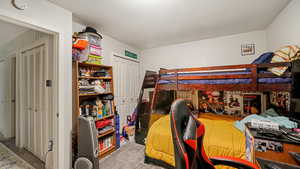 Carpeted bedroom featuring a closet