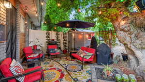 Fenced backyard featuring a patio area, area for grilling, an outdoor hangout area, and an outbuilding