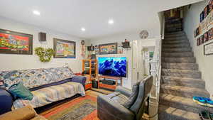 Living room featuring stairway and recessed lighting