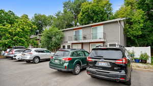 View of front of house with brick siding and a balcony