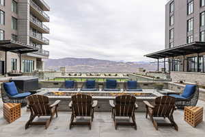 View of patio with a mountain view and an outdoor fire pit