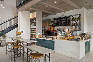 Bar with a wood ceiling with exposed beams and open shelves