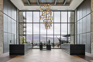 Building lobby with a high ceiling, expansive windows, and a mountain view