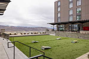 Surrounding community with a mountain view and a patio area