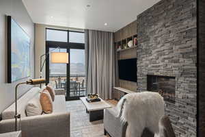 Living area featuring built in shelves, expansive windows, light wood finished floors, and a fireplace