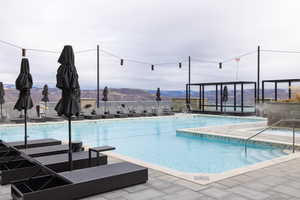Community pool with a mountain view and a patio