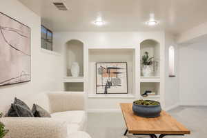 Living area with built in features and carpet