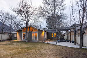 Back of property featuring a patio area, a pergola, french doors, and stucco siding