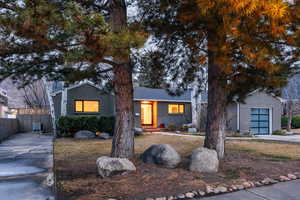View of front of house featuring brick siding, concrete driveway, and entry steps