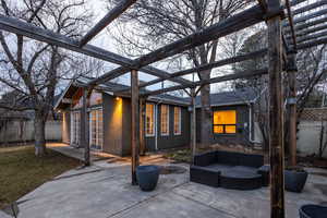 View of patio with an outdoor hangout area and a pergola
