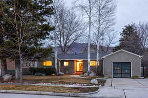 Ranch-style house with concrete driveway, an attached garage, and brick siding