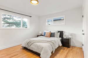 Bedroom with baseboards and light wood-style floors