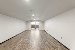 Bonus room featuring vaulted ceiling and wood finished floors
