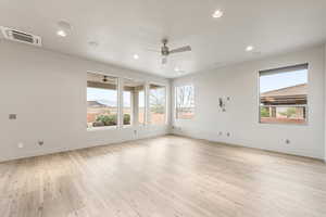 Spare room featuring light wood finished floors, cooling unit, ceiling fan, recessed lighting, and a mountain view