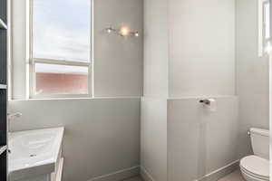 Half bathroom with toilet and vanity