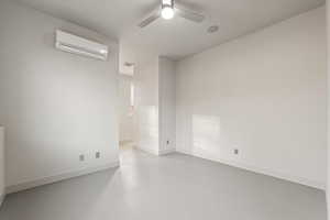 Empty room with concrete floors and ceiling fan