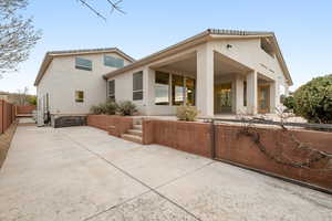 Back of house with a patio area and stucco siding