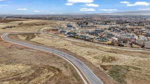 Aerial overview of property's location with a mountainous background and nearby suburban area