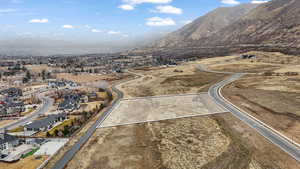 Aerial perspective of suburban area featuring a mountainous background and property boundaries highlighted