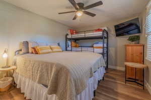 Bedroom featuring wood finished floors and a ceiling fan