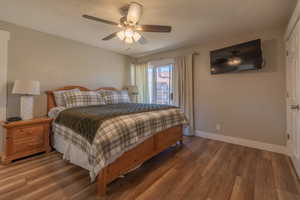 Bedroom featuring wood finished floors and a ceiling fan