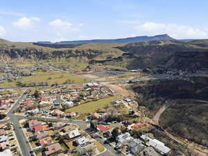 Aerial overview of property's location featuring a mountainous background and nearby suburban area