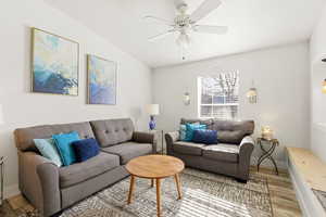 Living room with wood finished floors and a ceiling fan