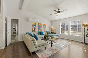 Living room featuring wood finished floors, a ceiling fan, and lofted ceiling with beams
