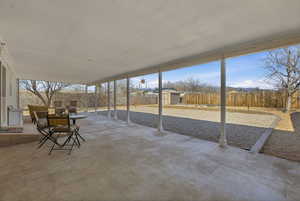 Fenced backyard with a shed and a patio