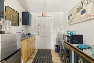 Kitchen featuring stainless steel appliances, electric panel, and a textured ceiling