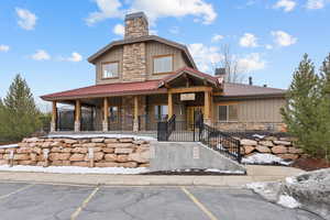 View of building exterior with uncovered parking