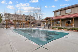 Community pool with a patio