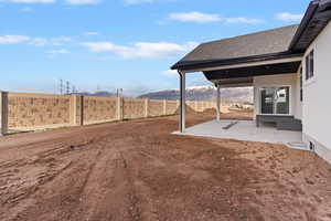 View of yard with a patio, a mountain view, and entry steps