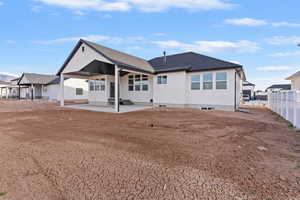 Back of property featuring a patio area and a shingled roof