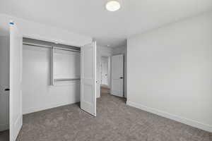 Unfurnished bedroom featuring carpet floors and a closet