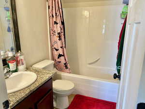 Bathroom with vanity and shower / bath combo