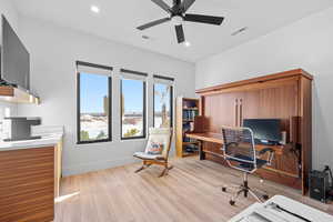 Office area with light wood-style flooring, a ceiling fan, and recessed lighting
