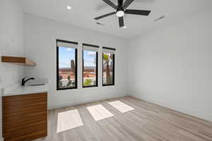 Spare room featuring wood tiled floors and a ceiling fan