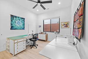 Office space featuring light wood-type flooring, ceiling fan, and recessed lighting