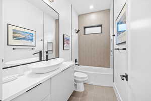 Full bath with vanity, shower / tub combination, light tile patterned floors, and recessed lighting
