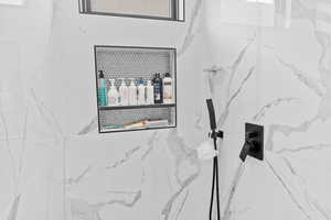 Bathroom view of a marble finish shower